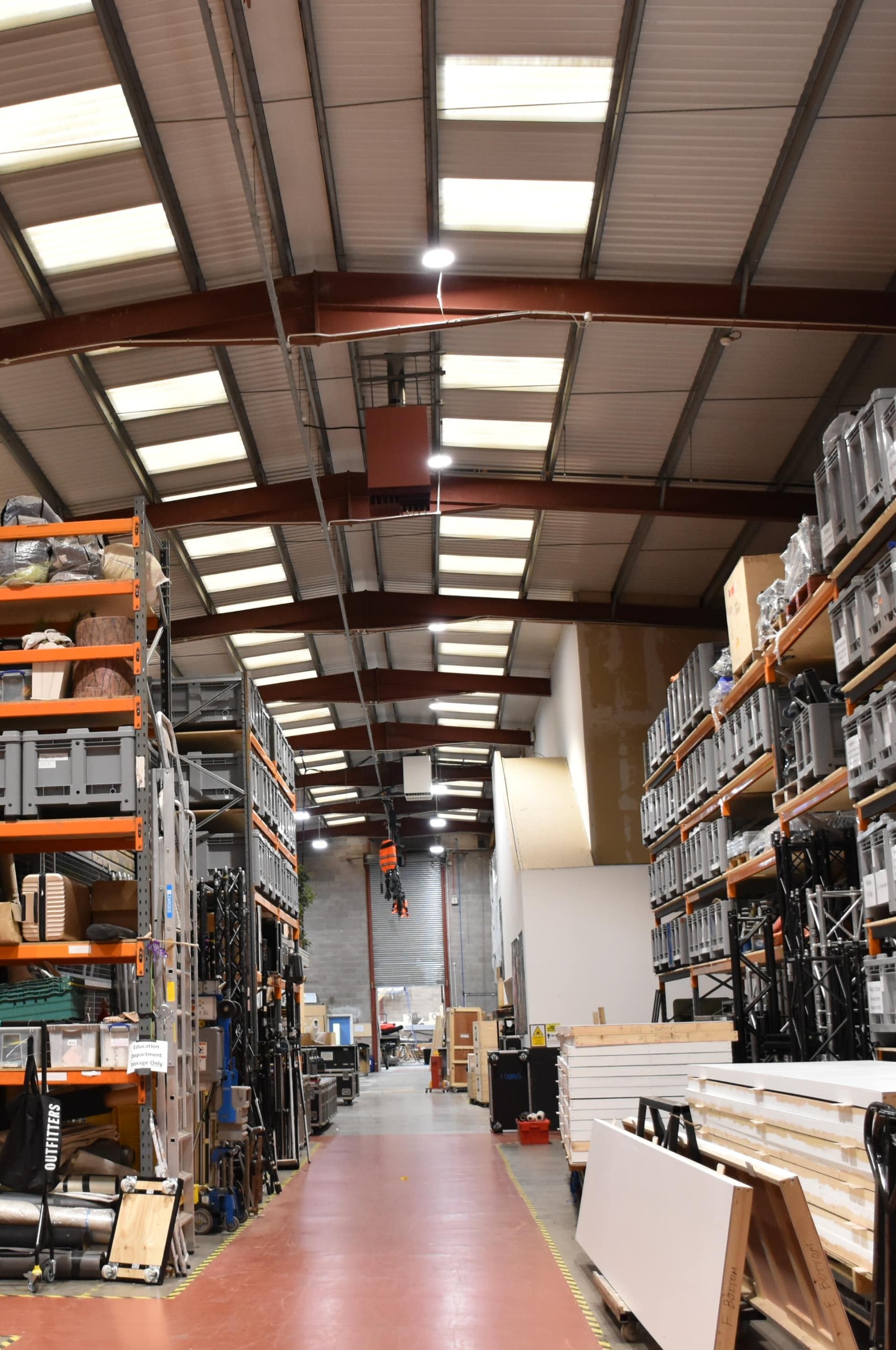 High-bay LED lighting over warehouse racking and aisles