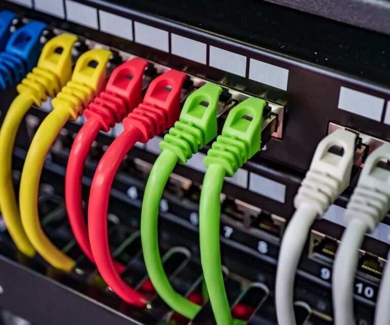 Commercial data cabinet with organised patch panels and connected equipment
