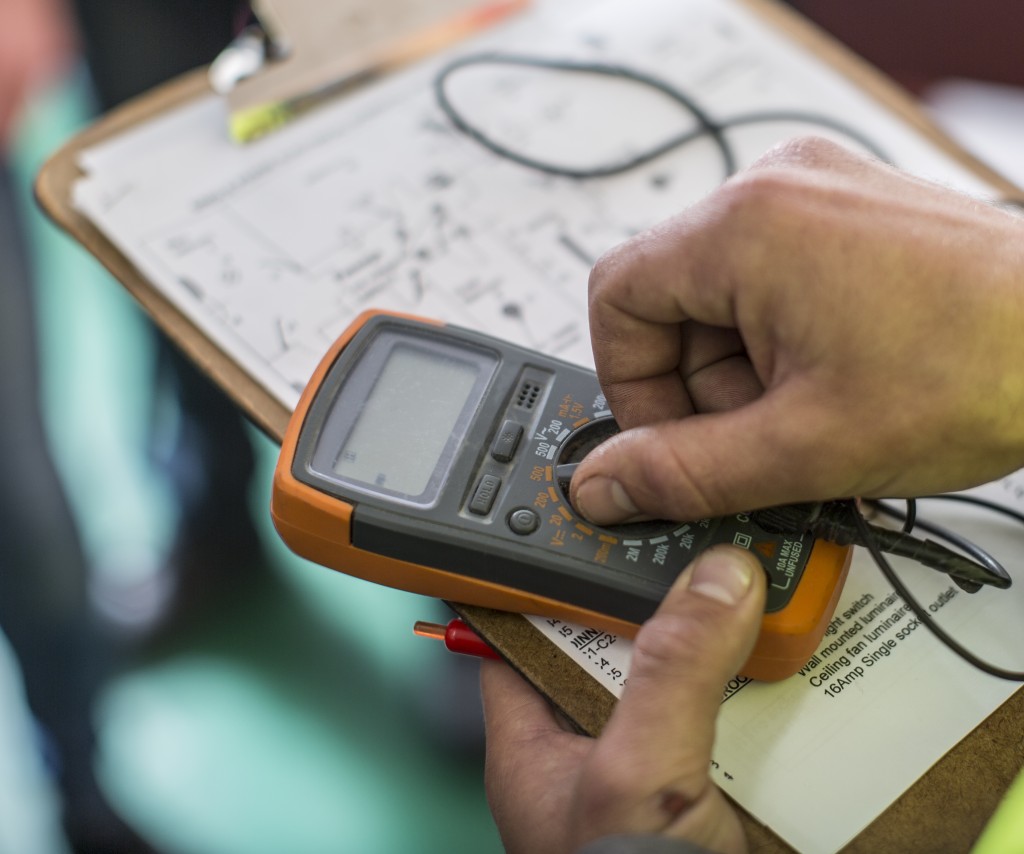 An electrician performing a test inspection