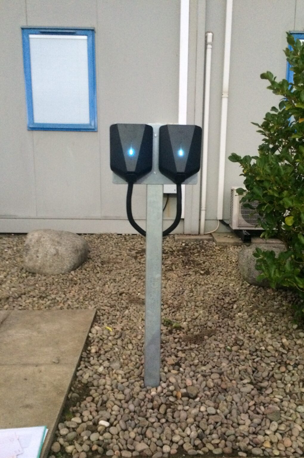 Fleet electric vehicles using charging infrastructure at a commercial site