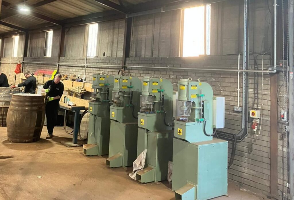 Whisky distillery still house, copper stills and process pipework