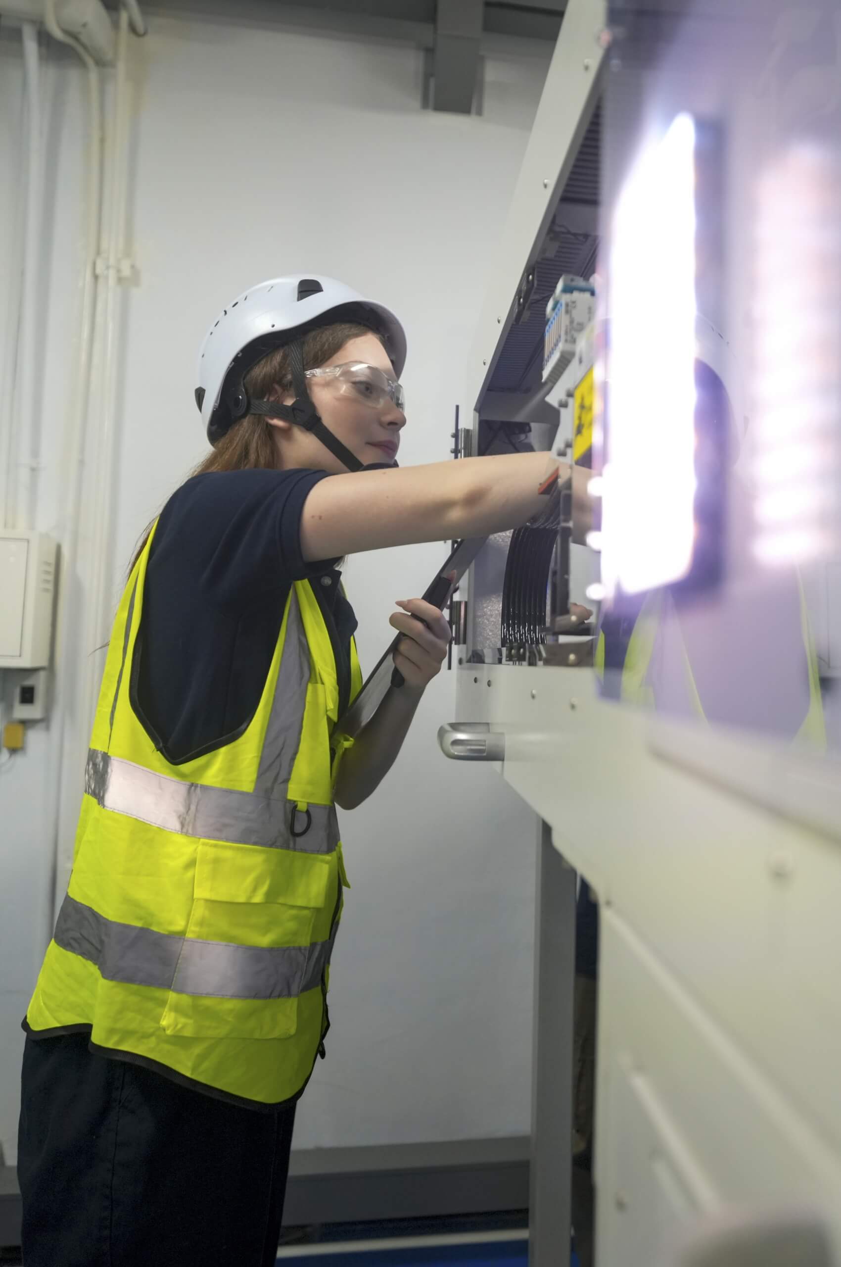 Engineer working on distribution board during emergency lighting installation