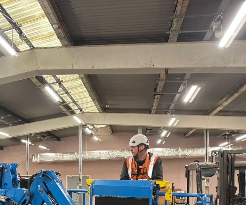 WB Electrical Engineer in MEWP working under industrial ceiling lighting, factory lighting installation