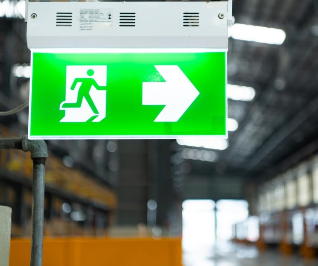 Emergency exit sign in industrial building, emergency lighting compliance support