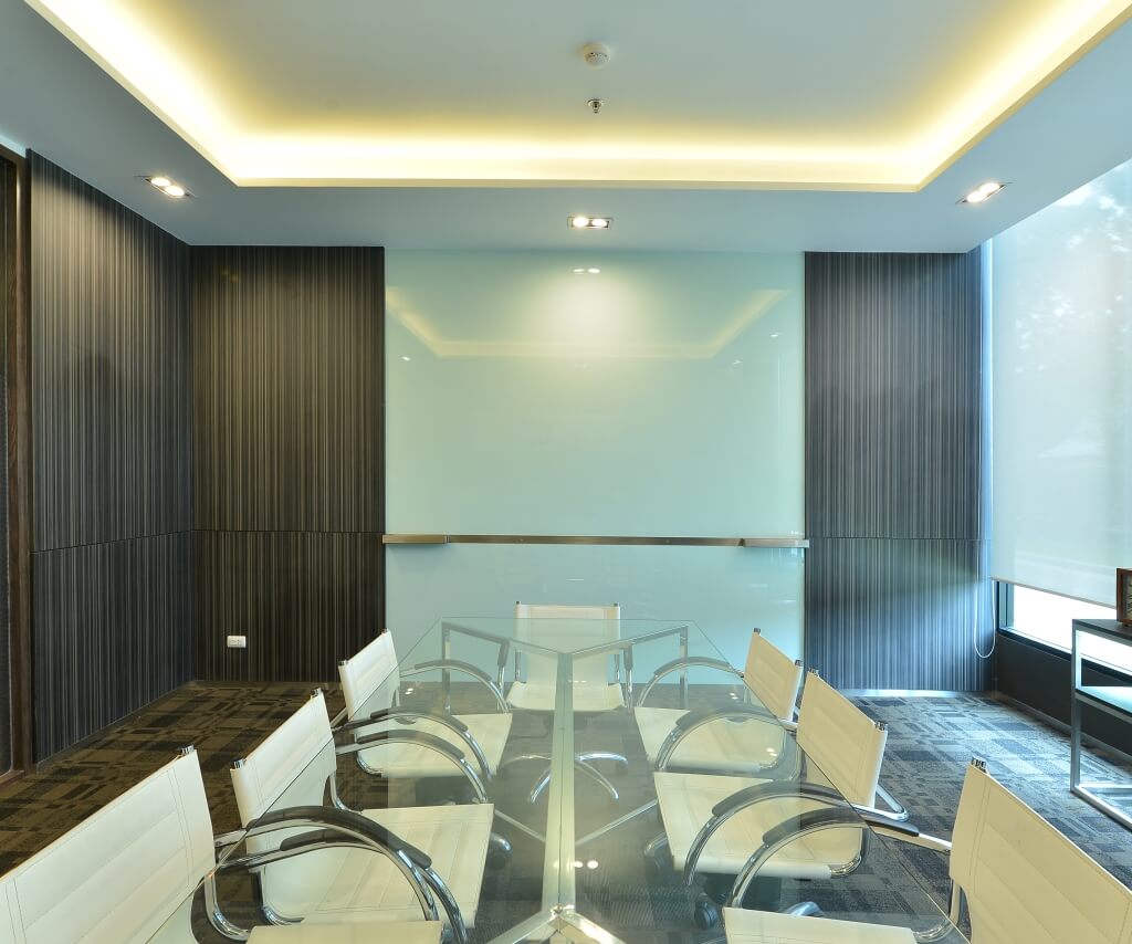 Boardroom lighting with LED downlights and perimeter cove lighting, consistent meeting room illumination