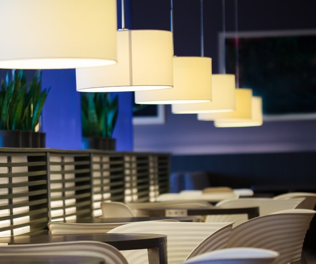 Pendant LED lighting in hospitality seating area, warm ambience lighting